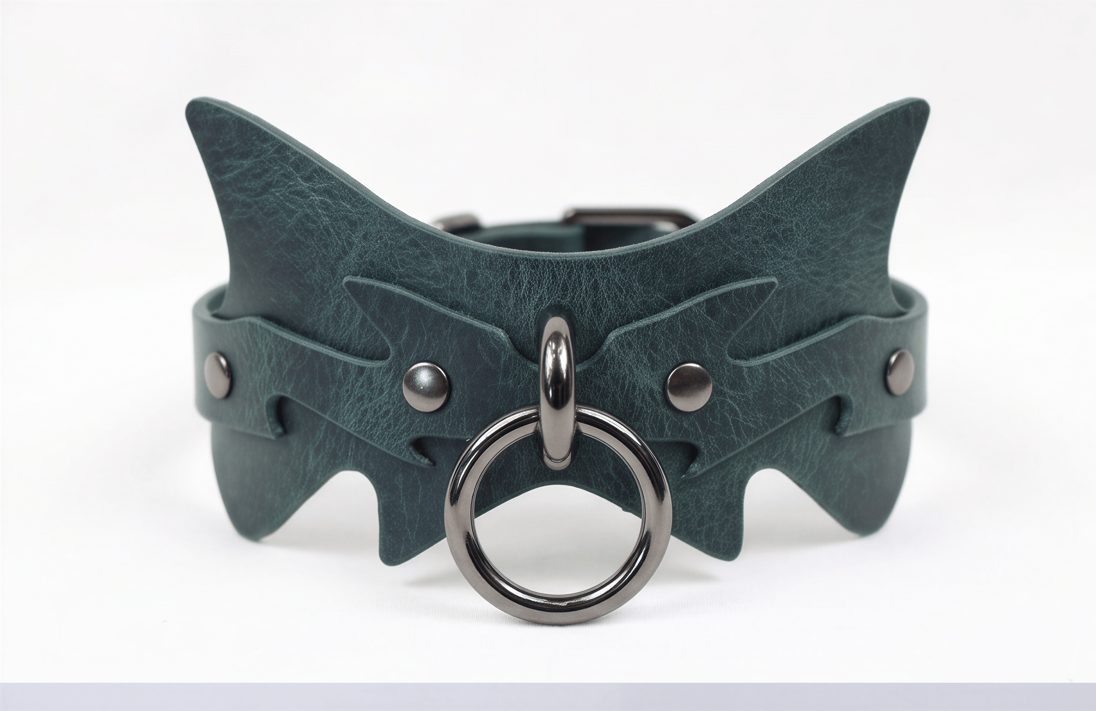A green leather choker necklace with a metal ring and a metal buckle.