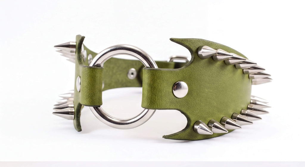 A green leather collar with silver spikes protruding from it.