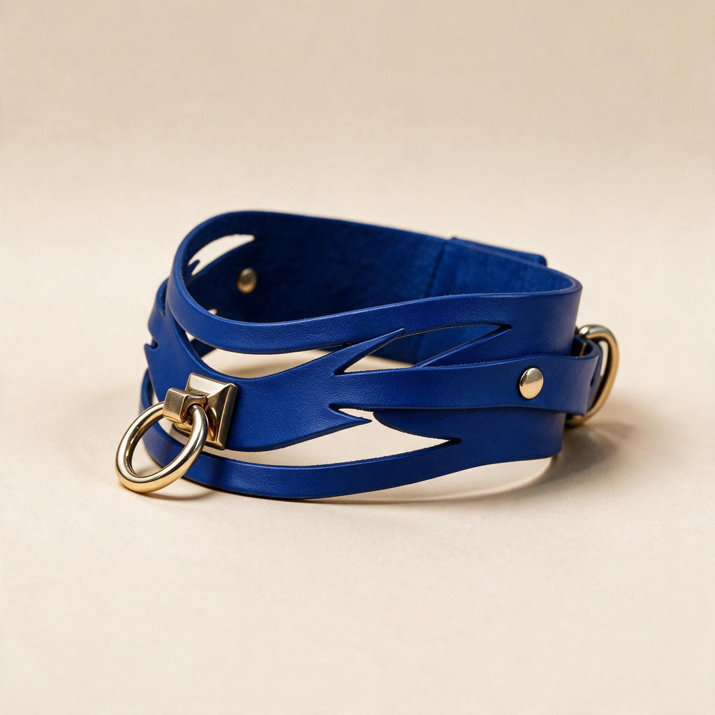A blue leather choker necklace with gold-colored metal rings and a clasp.