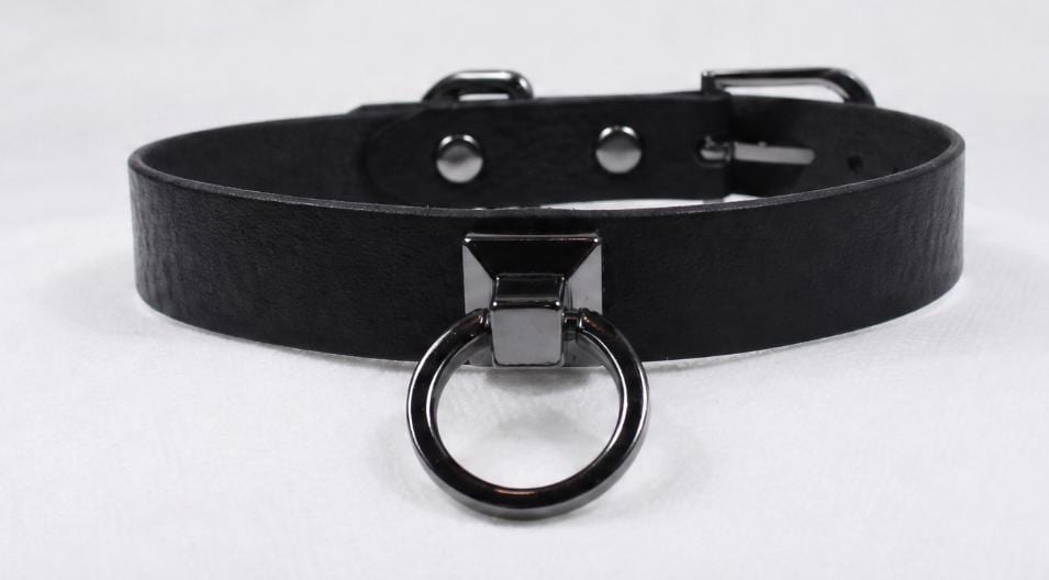 A black leather choker collar with a metal ring and buckle.