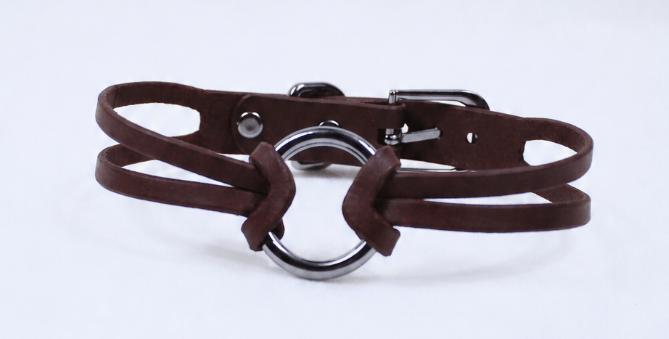 A brown leather choker necklace with a metal ring buckle.