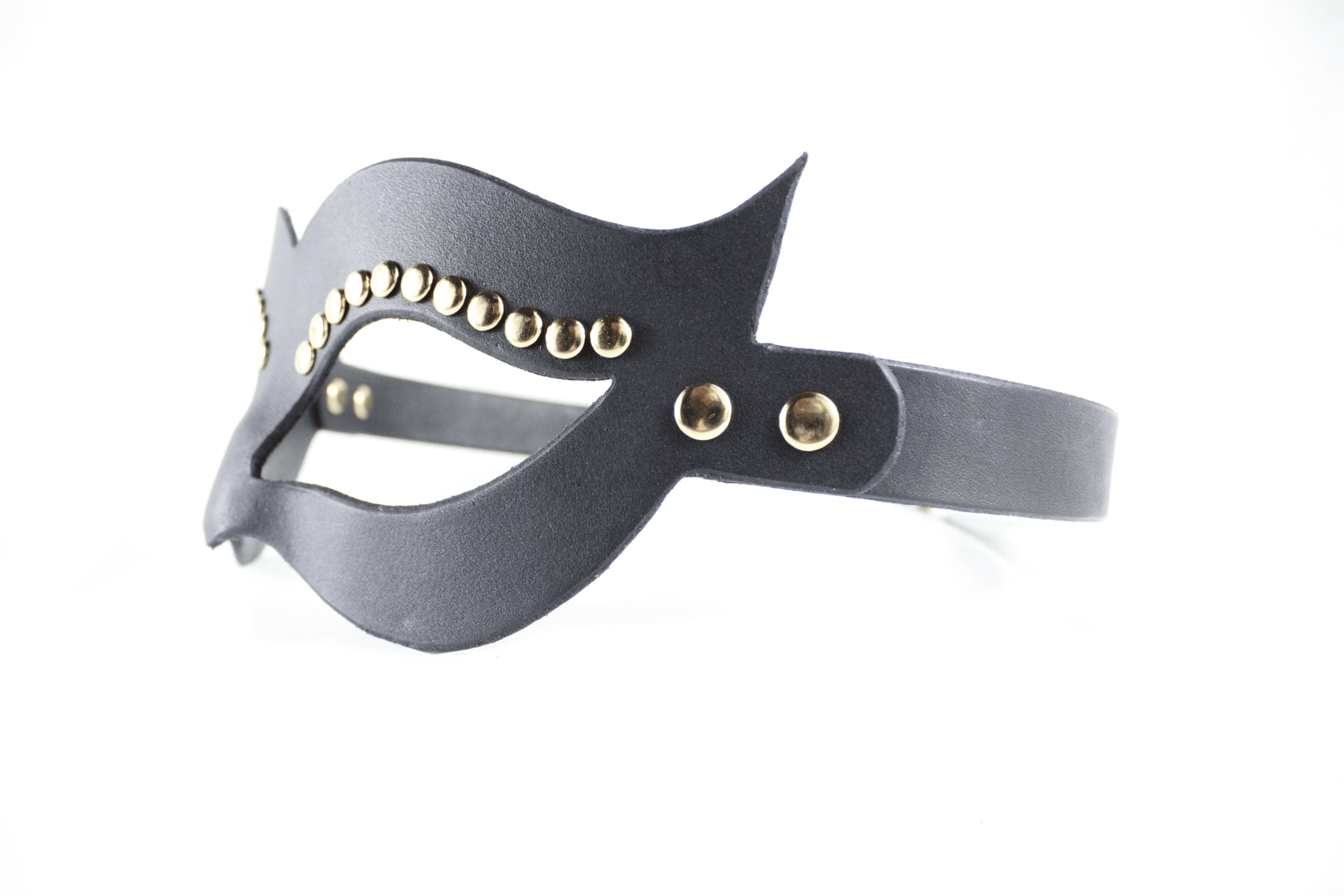 A black leather mask with gold studs on the sides.