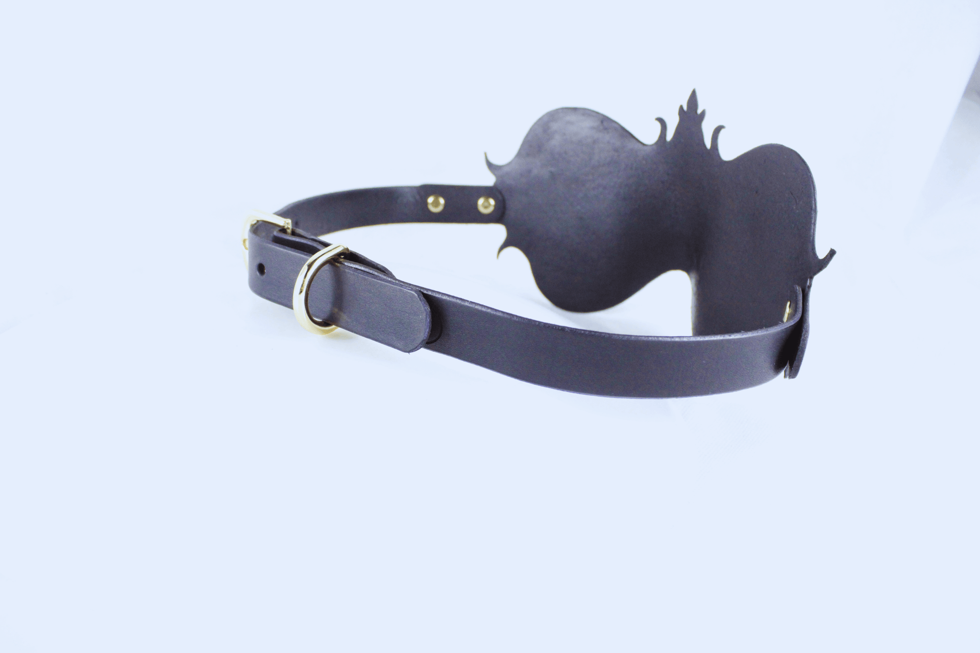 A black leather strap with a decorative design on the back, possibly a headband or accessory.