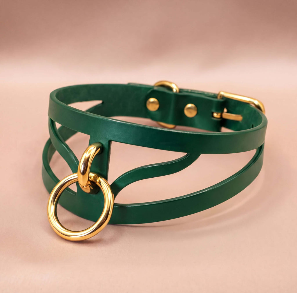 A green leather choker necklace with a gold-colored metal ring and buckle.