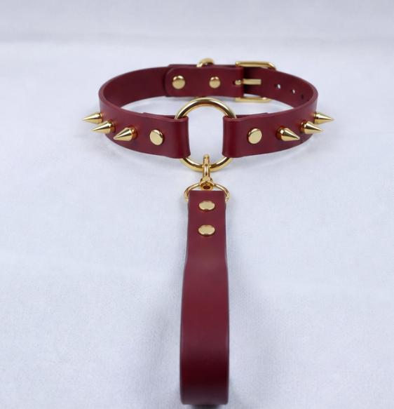 A burgundy leather choker collar with gold studs and a gold-colored metal clasp.