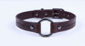 A brown leather choker collar with a metal ring and a cross pattern on the strap.