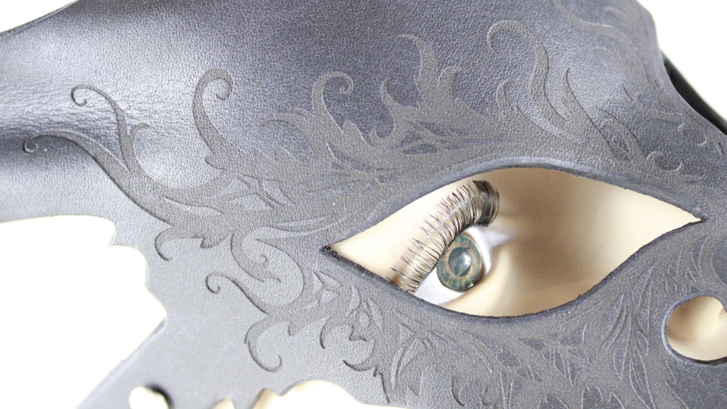 a close-up view of a detailed, intricate eye mask with a dark, embossed design.