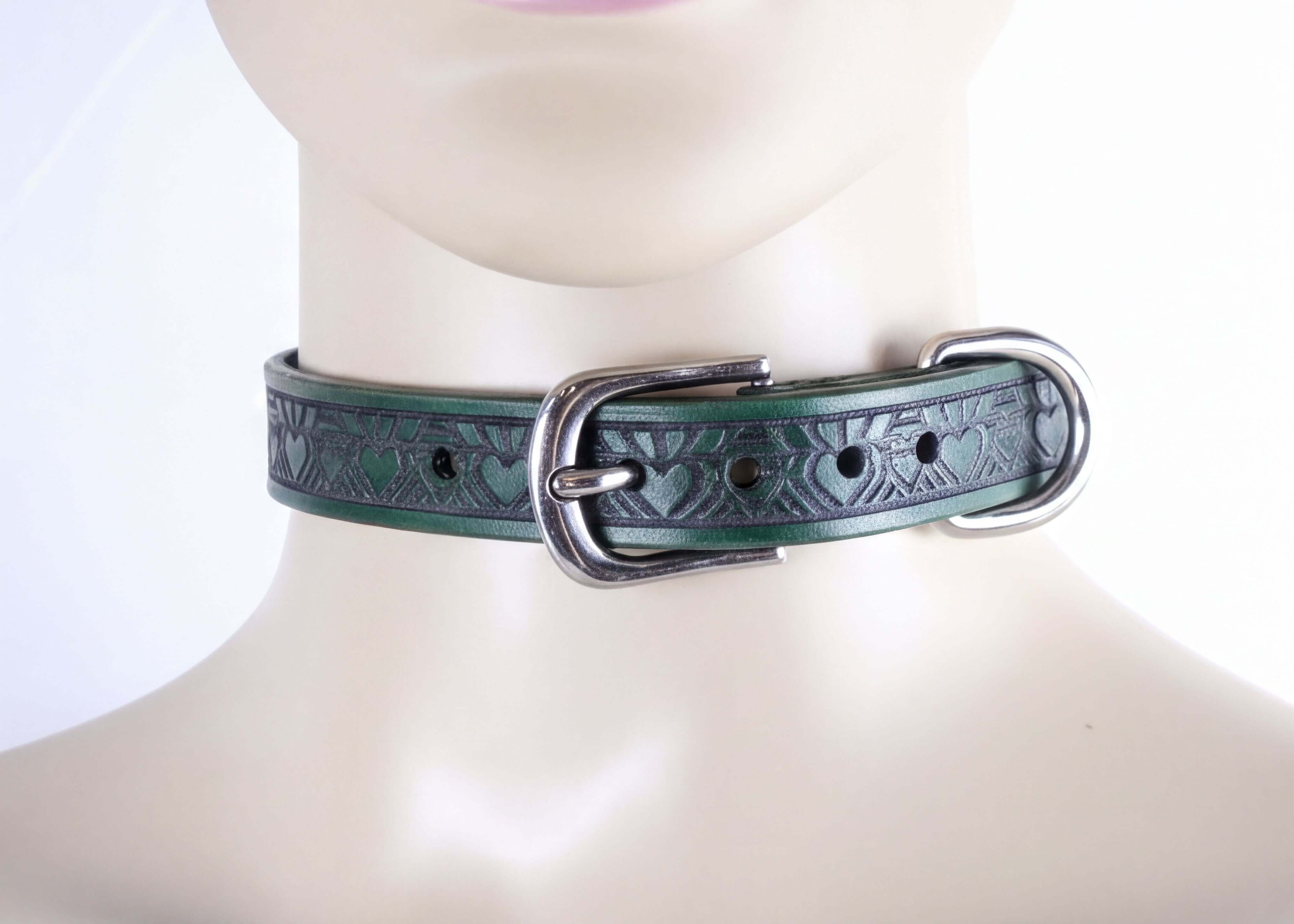A close-up image of a green leather choker necklace with a metal buckle.