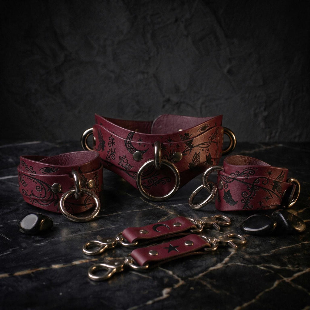 A set of burgundy leather choker necklaces and straps with intricate designs, including floral and celestial motifs, displayed on a dark surface.
