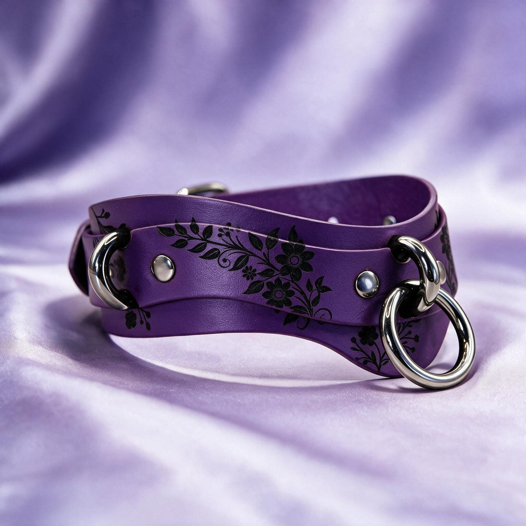 A purple leather choker necklace with a floral design and metal rings.