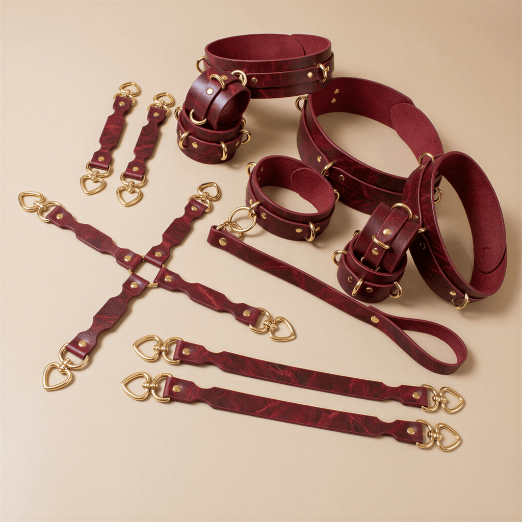 a collection of burgundy leather straps and buckles, arranged on a beige background.