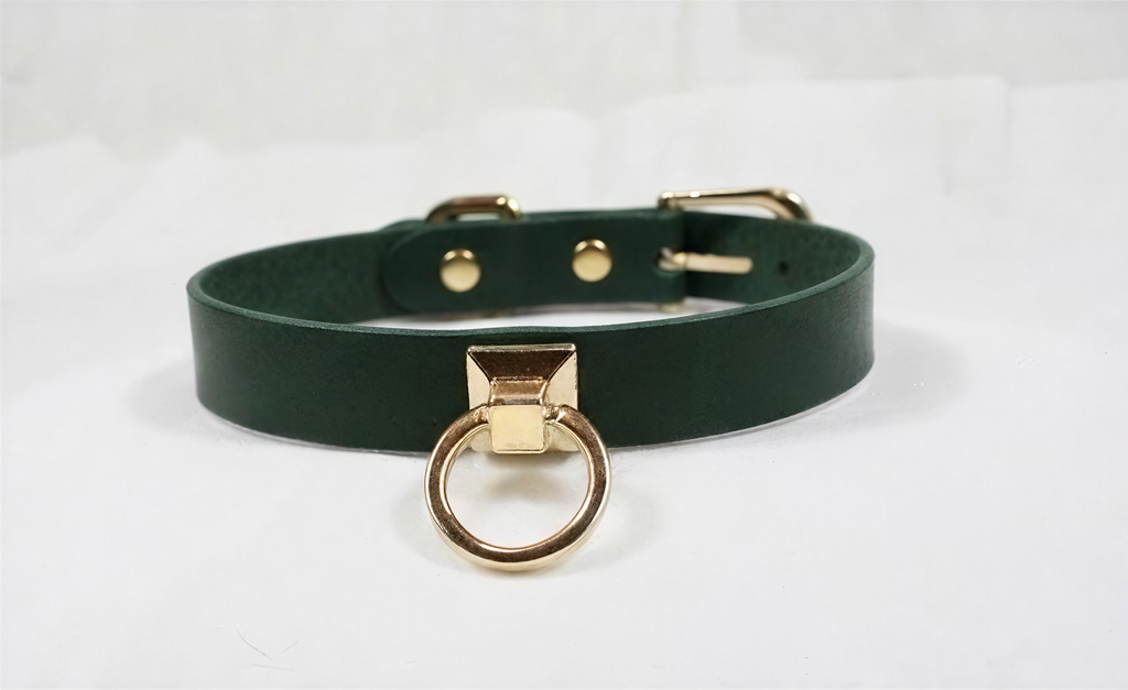 A dark green leather choker collar with a gold-colored metal ring and buckle.