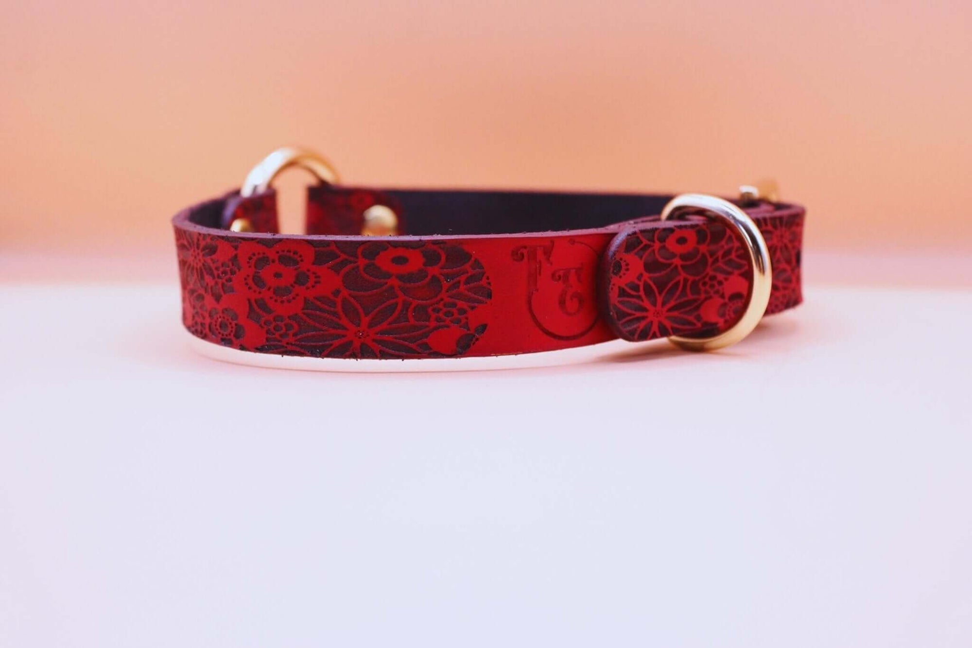 Handmade red floral leather collar with golden hardware, perfect for discreet sub wear and BDSM day collar styles.