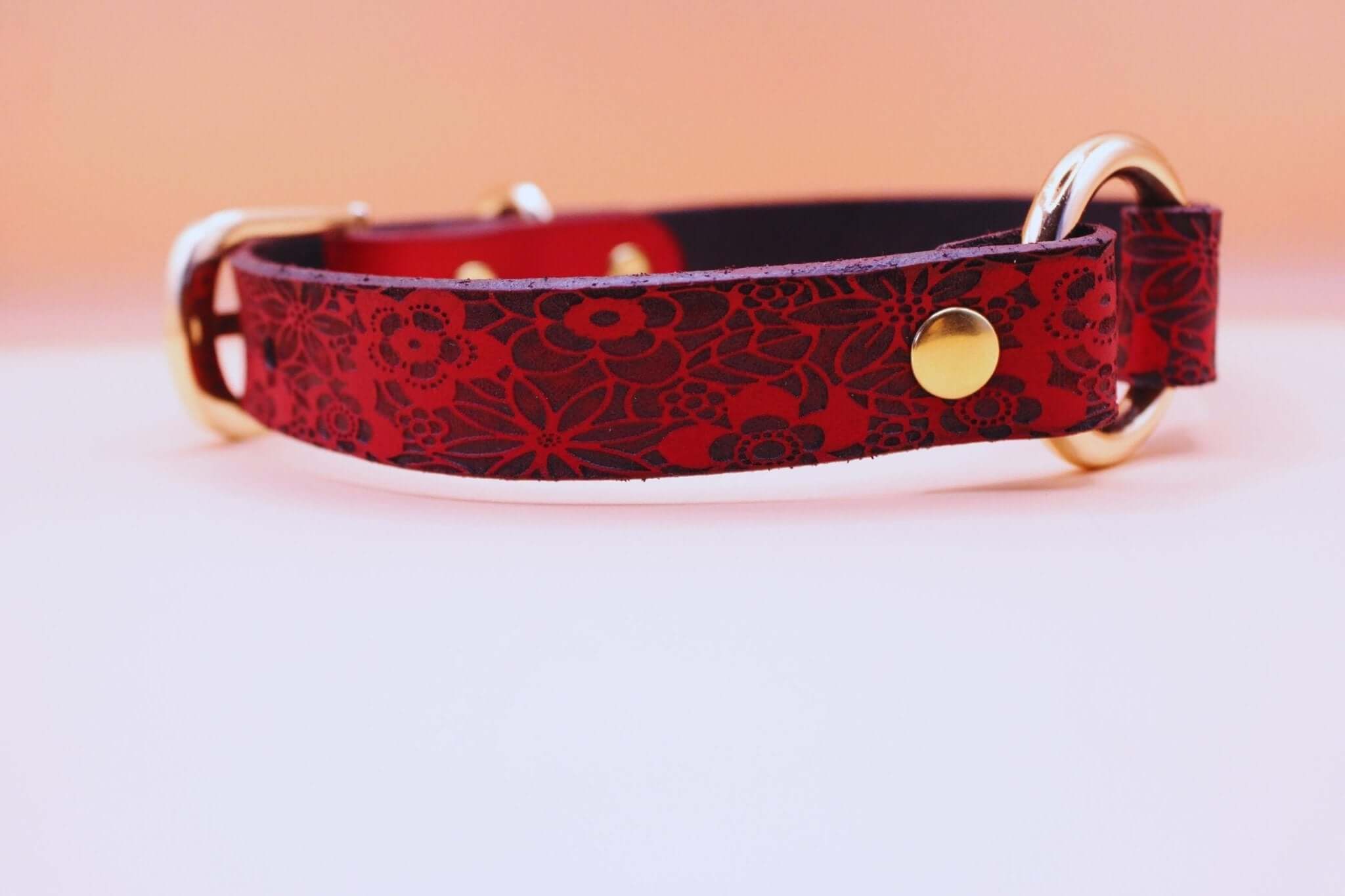 Handmade red leather collar with floral design, featuring golden hardware, perfect for discreet petplay and BDSM.