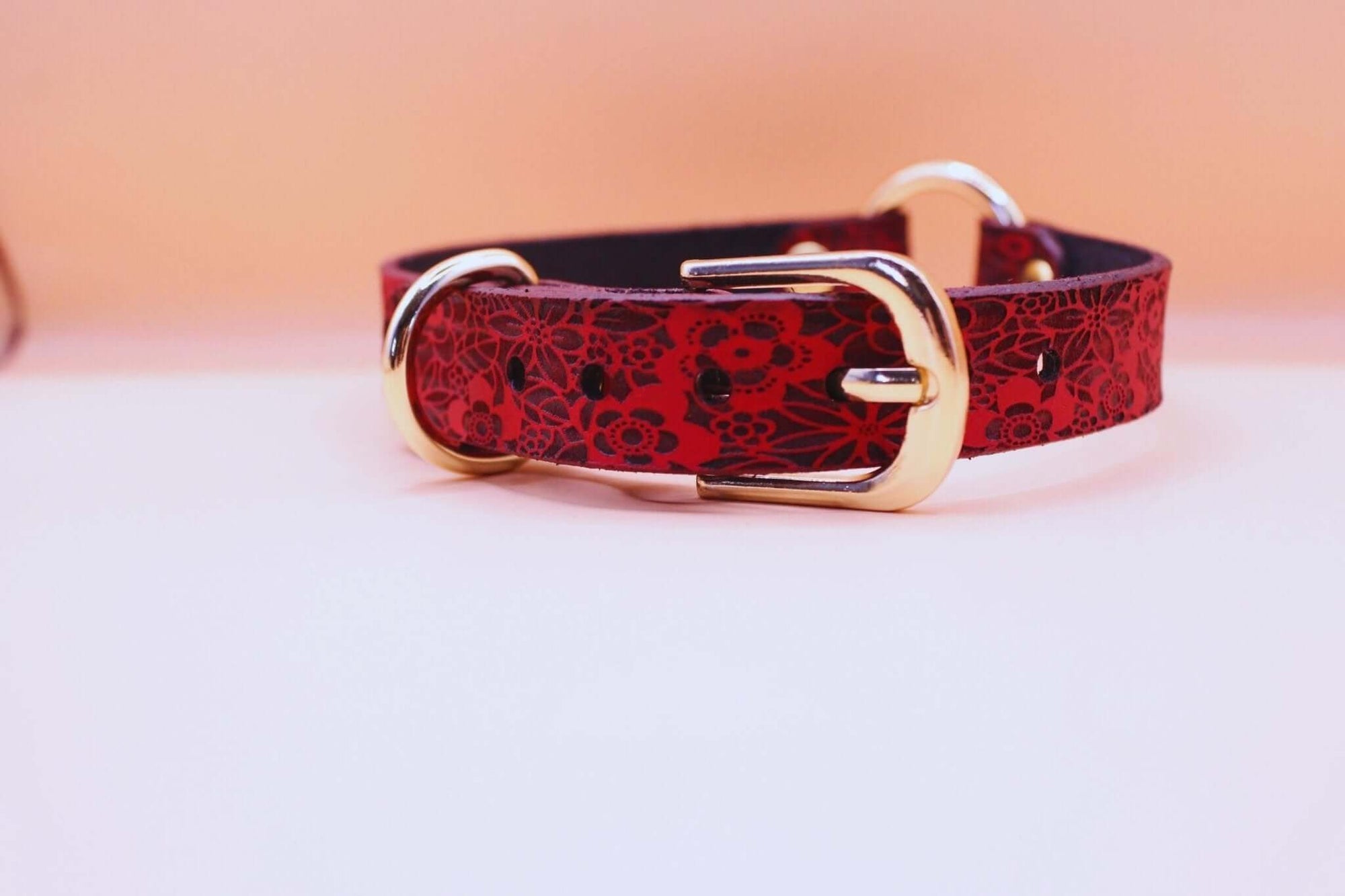 Elegant red floral leather collar with gold buckle, perfect as a discreet day collar for BDSM and submissive jewelry.