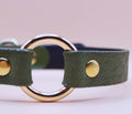 Discreet BDSM day collar in green leather with gold hardware, perfect for submissive jewelry and bondage gear.