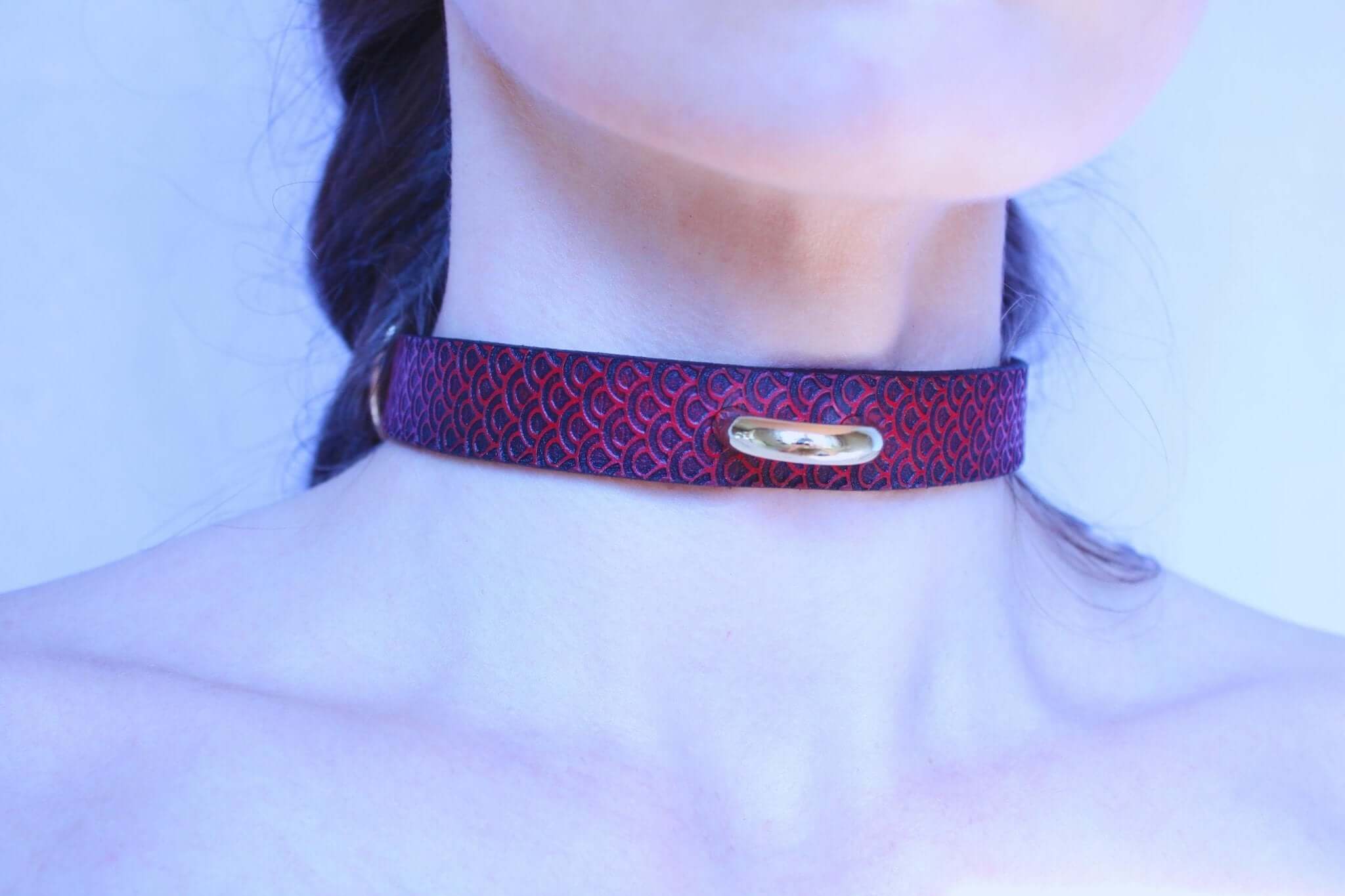 Discreet red leather submissive collar with unique scale texture, perfect for BDSM and elegant daily wear.