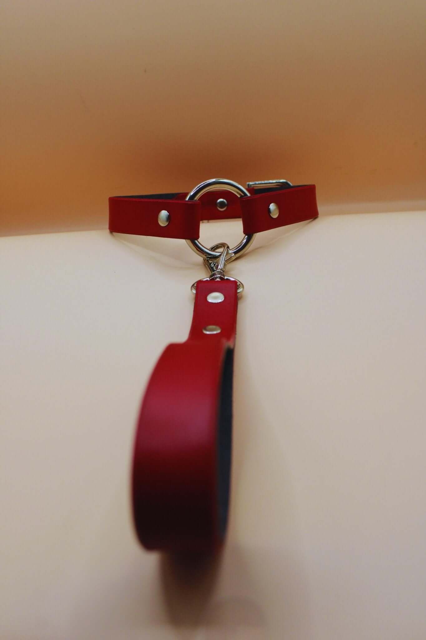 Discreet red leather sub collar with silver metal detailing, ideal for BDSM jewelry and bondage gear.