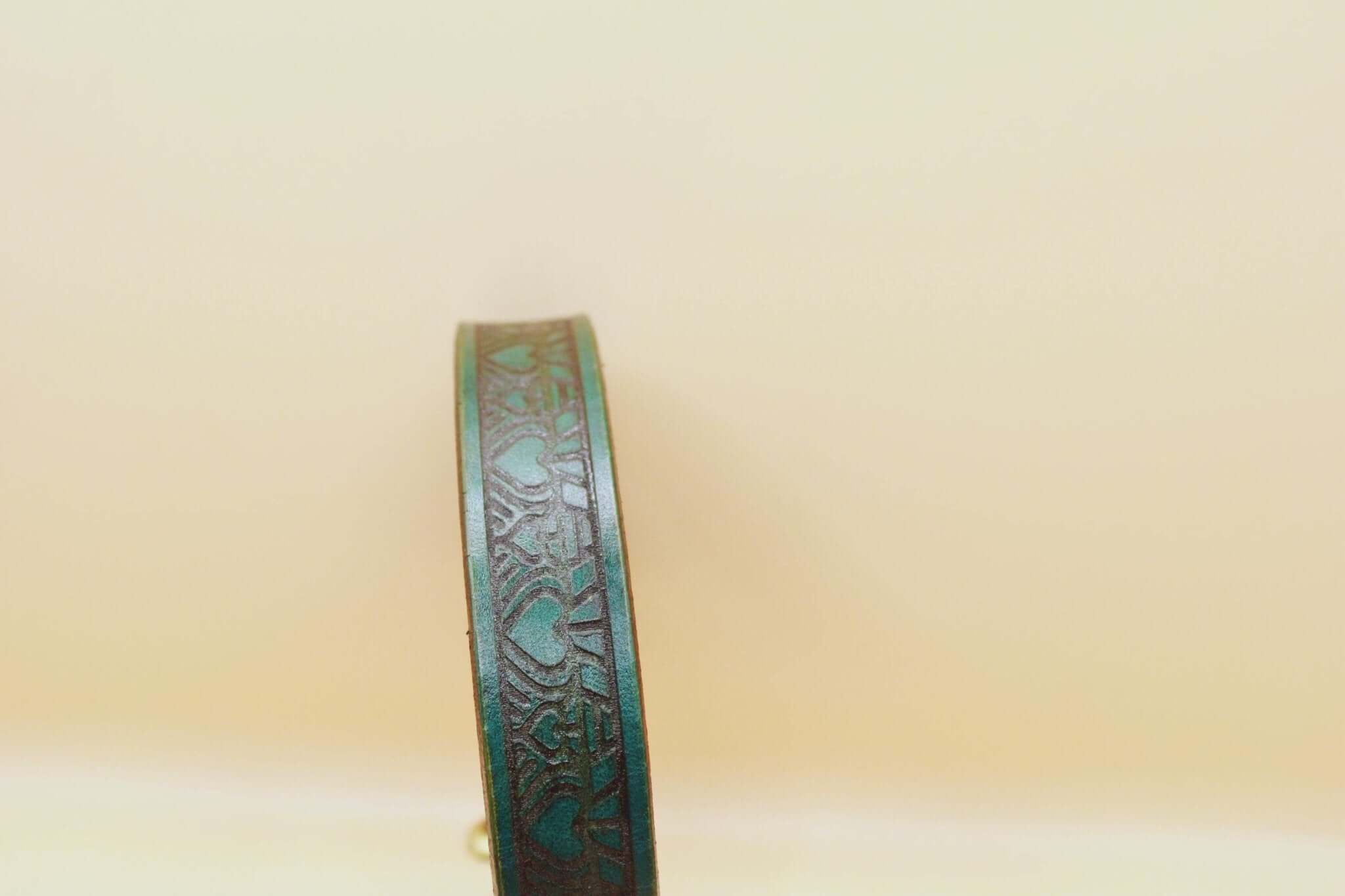 Elegant leather submissive day collar with intricate heart design, perfect for discreet BDSM and daily wear.