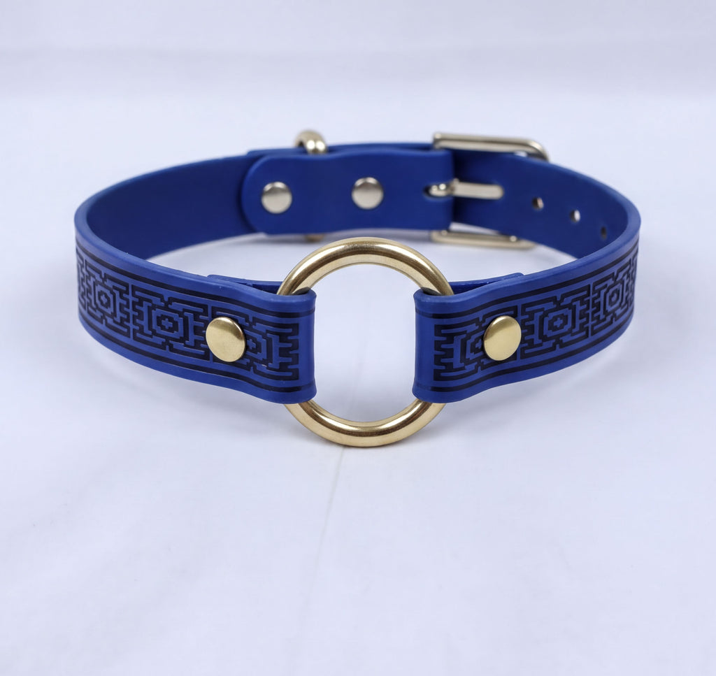 A blue braided collar with a gold ring and buckle.