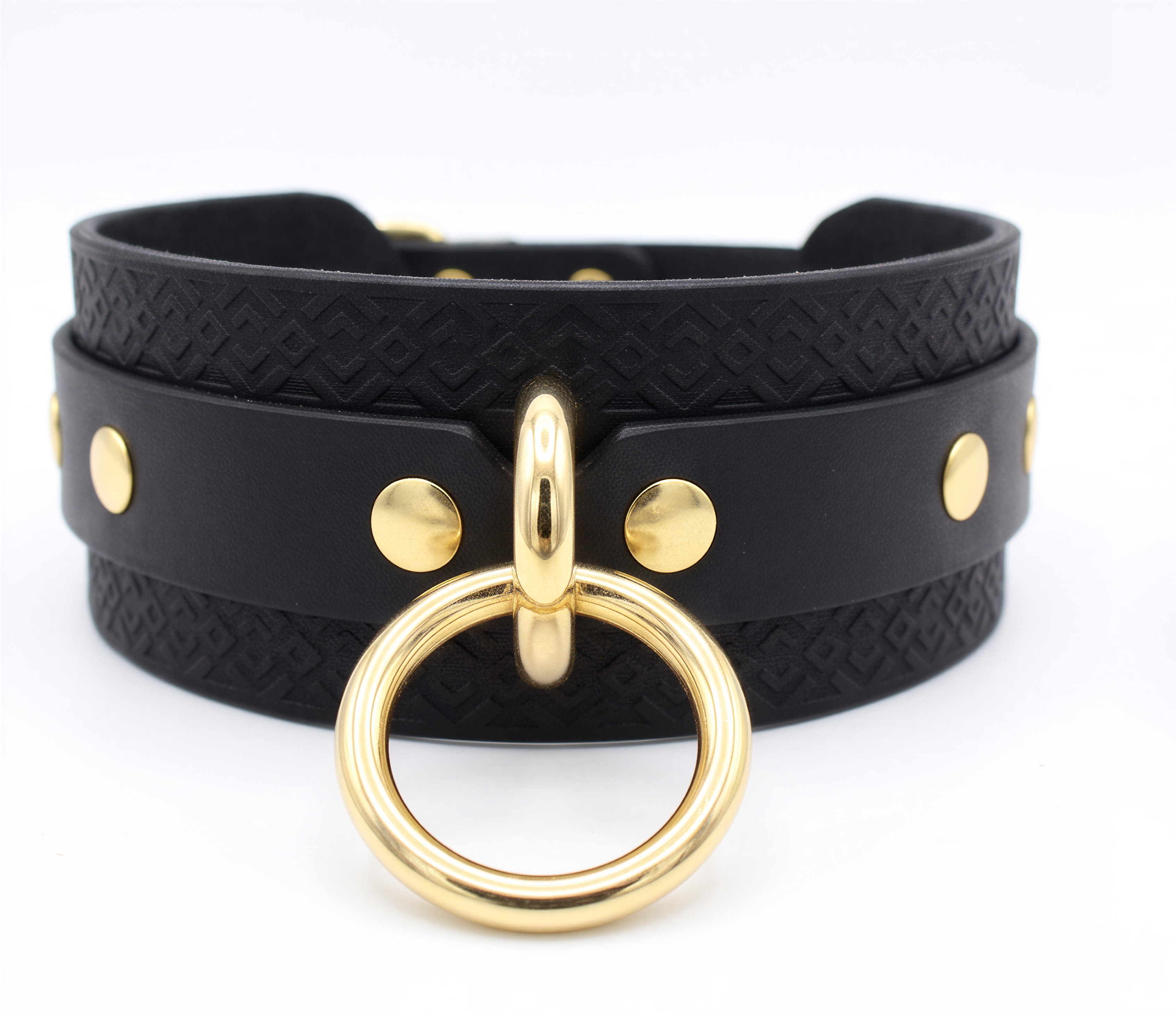 A black leather choker necklace with a gold ring and studs on the front.