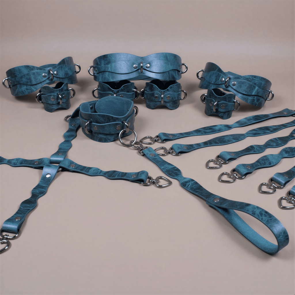 A collection of various leather straps and buckles in shades of blue and green, arranged on a beige background.