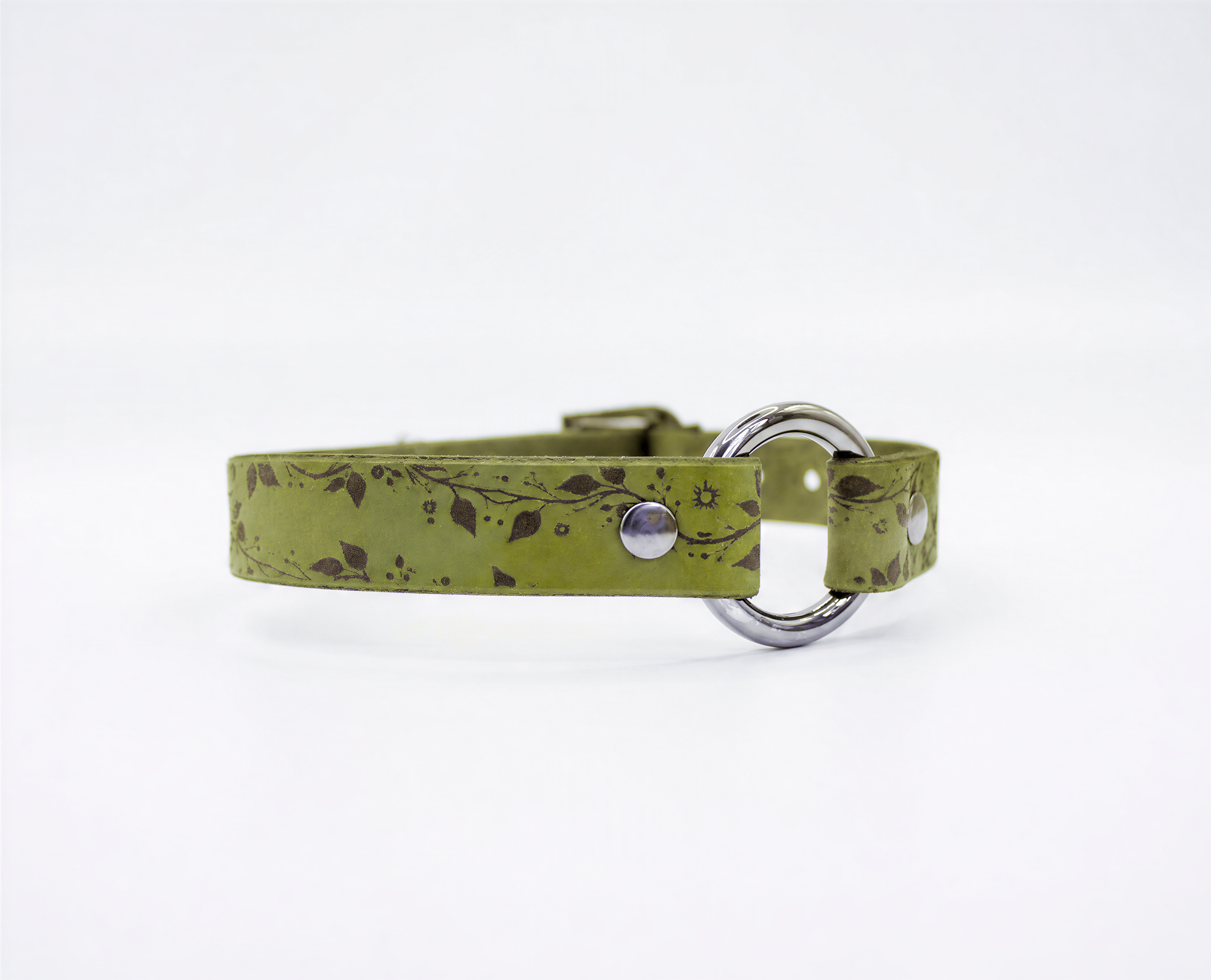 A green leather collar with a silver metal buckle and a floral pattern on the strap.