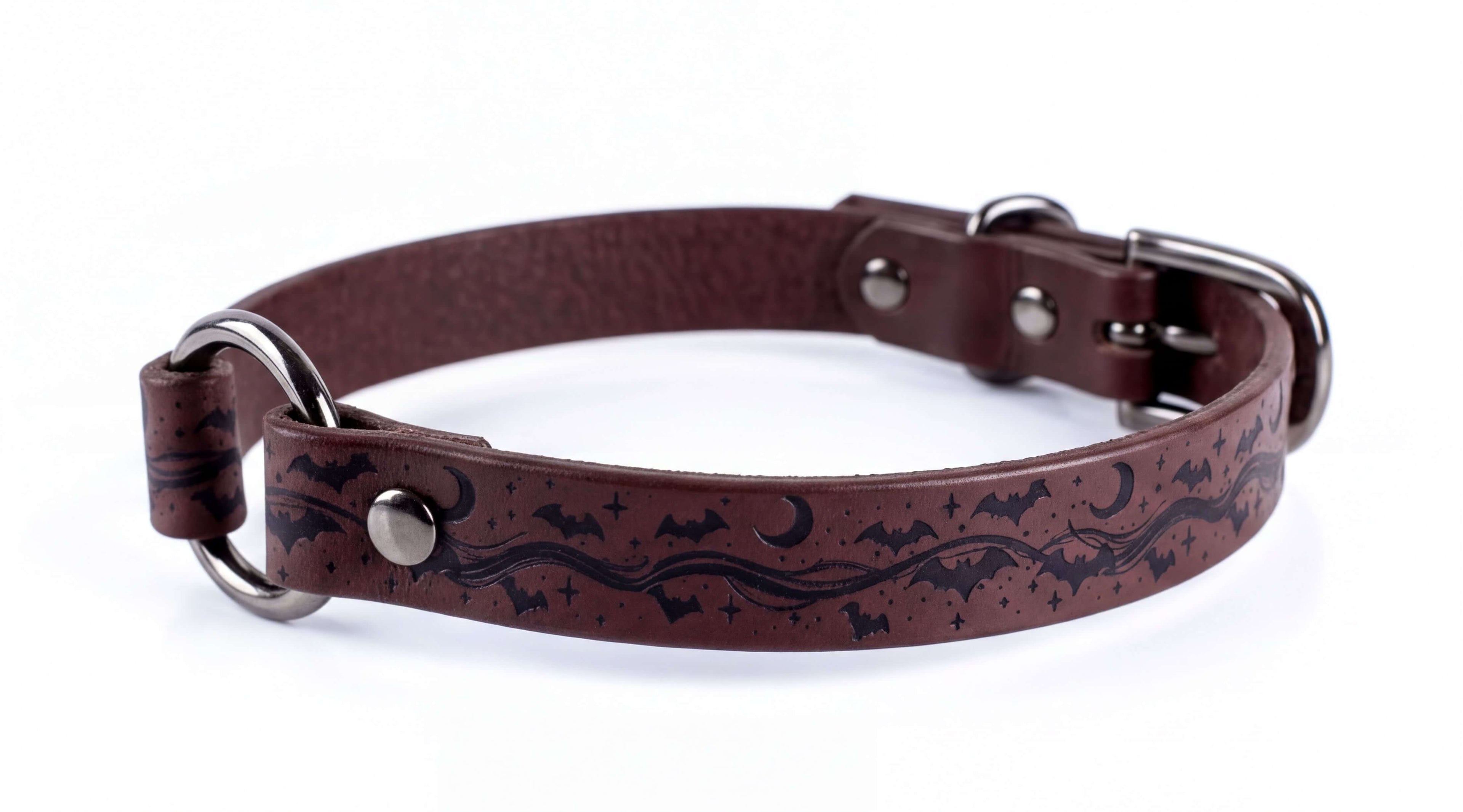 A brown leather dog collar with a night sky and bats design.