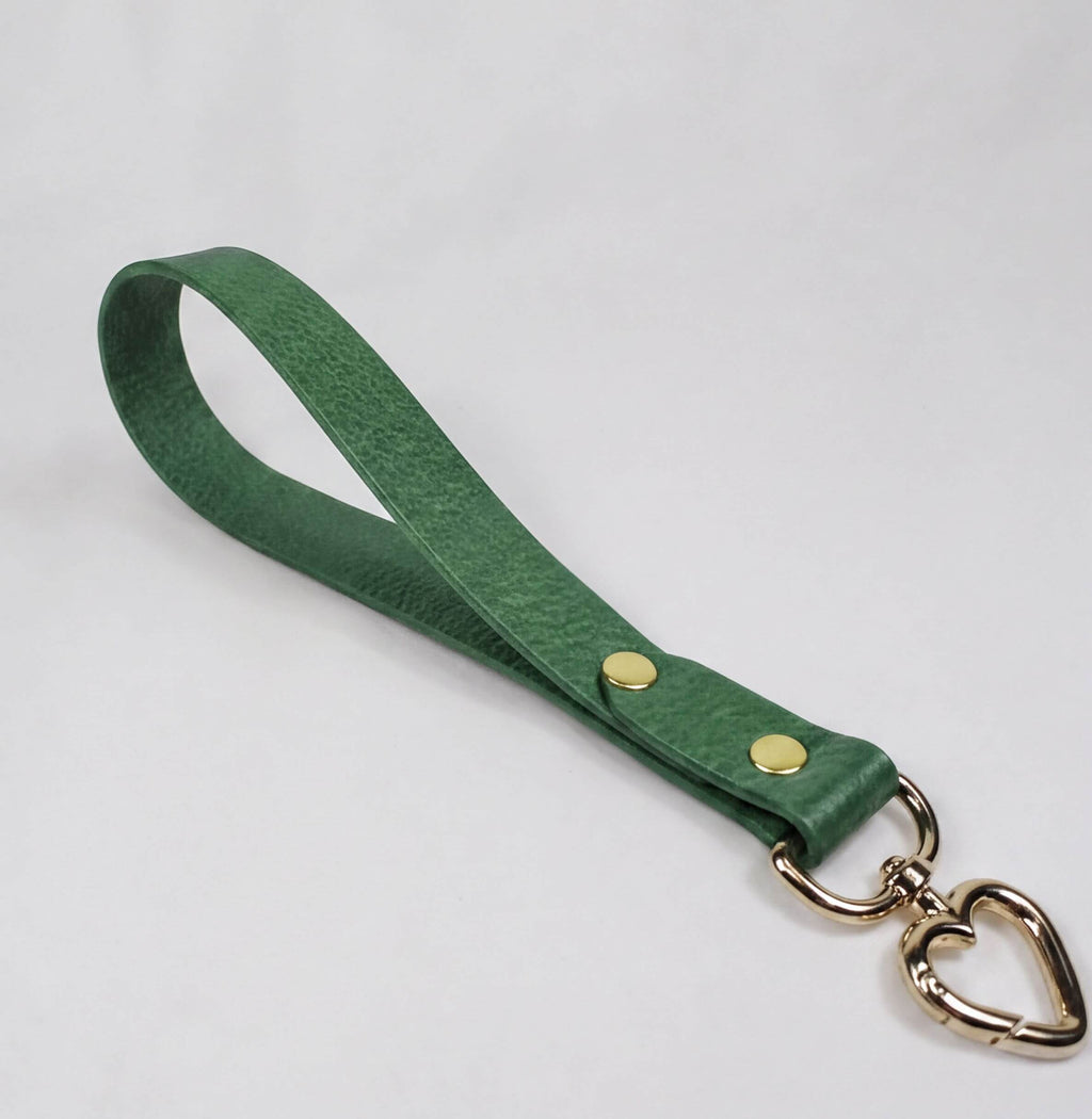 A green leather strap with a heart-shaped metal clasp attached to it.