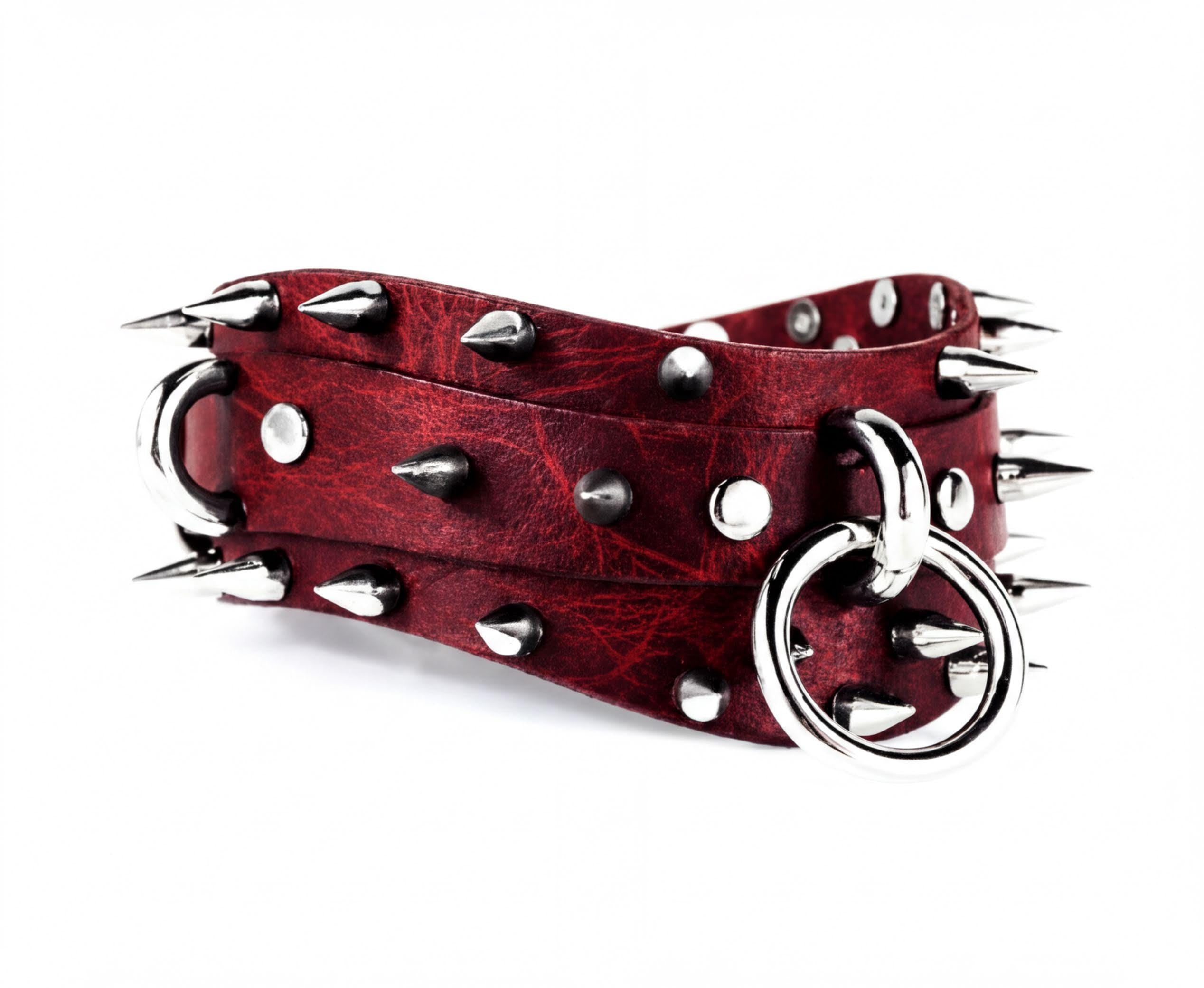 A red leather belt with silver spikes and a metal ring on it.