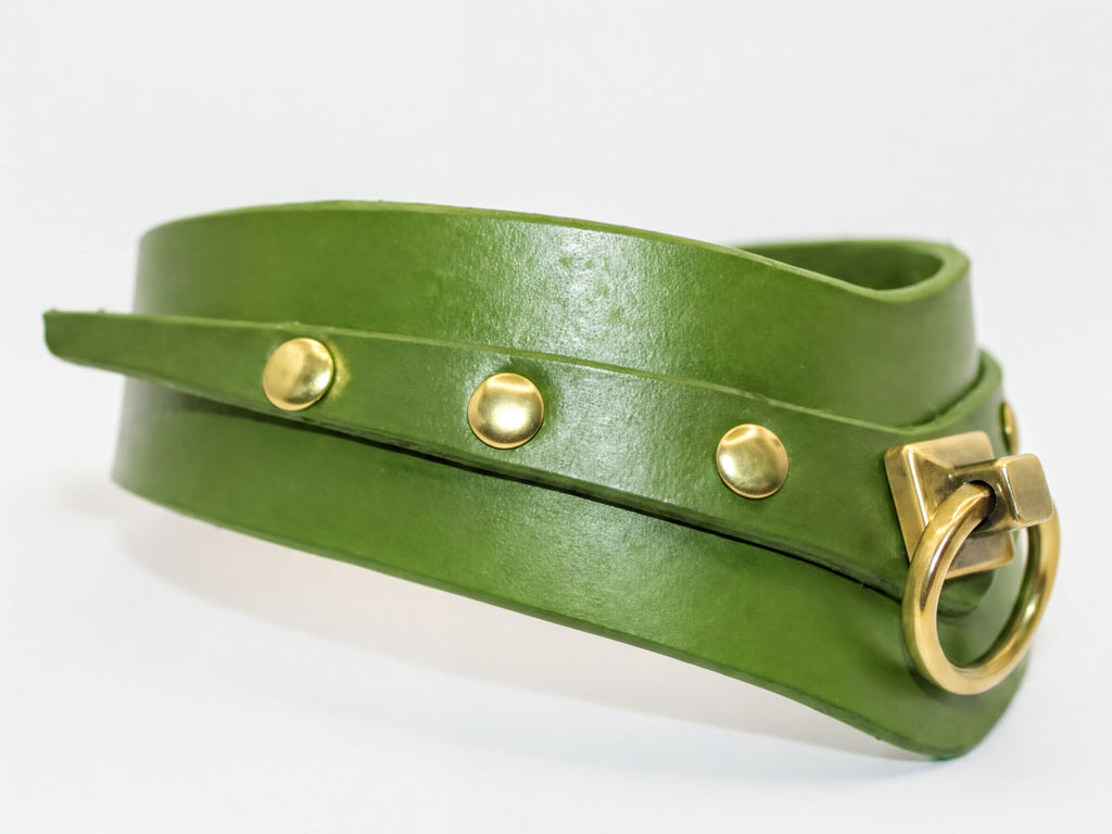 A green leather choker collar with a brass buckle and three round buttons.