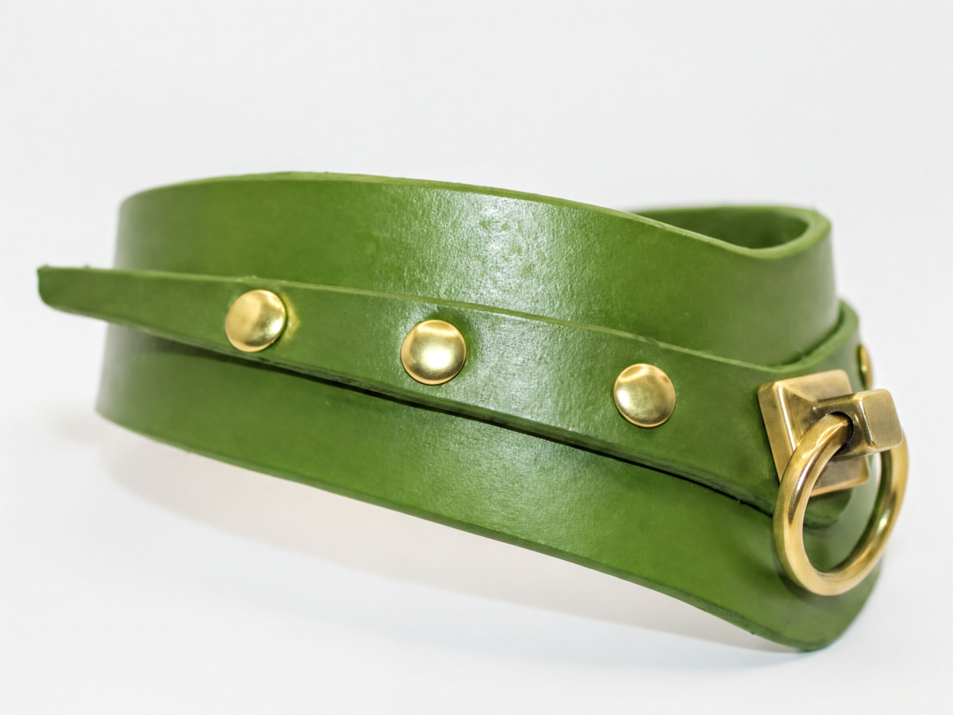 A green leather choker collar with a brass buckle and three round buttons.