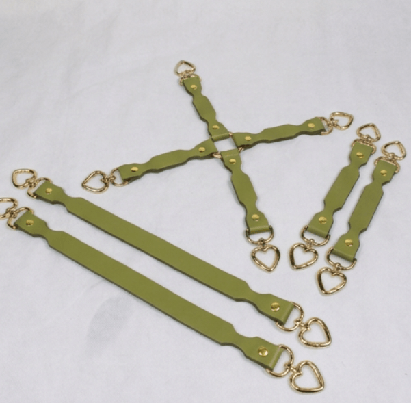 a collection of green leather straps with gold heart-shaped buckles, arranged in various orientations on a white background.