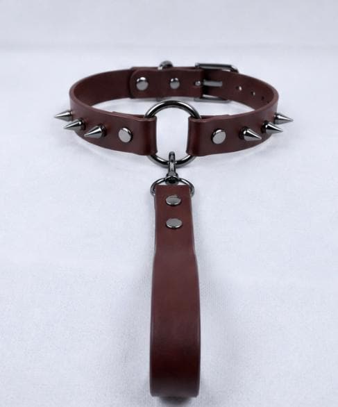 A brown leather choker necklace with spikes and a metal clasp.