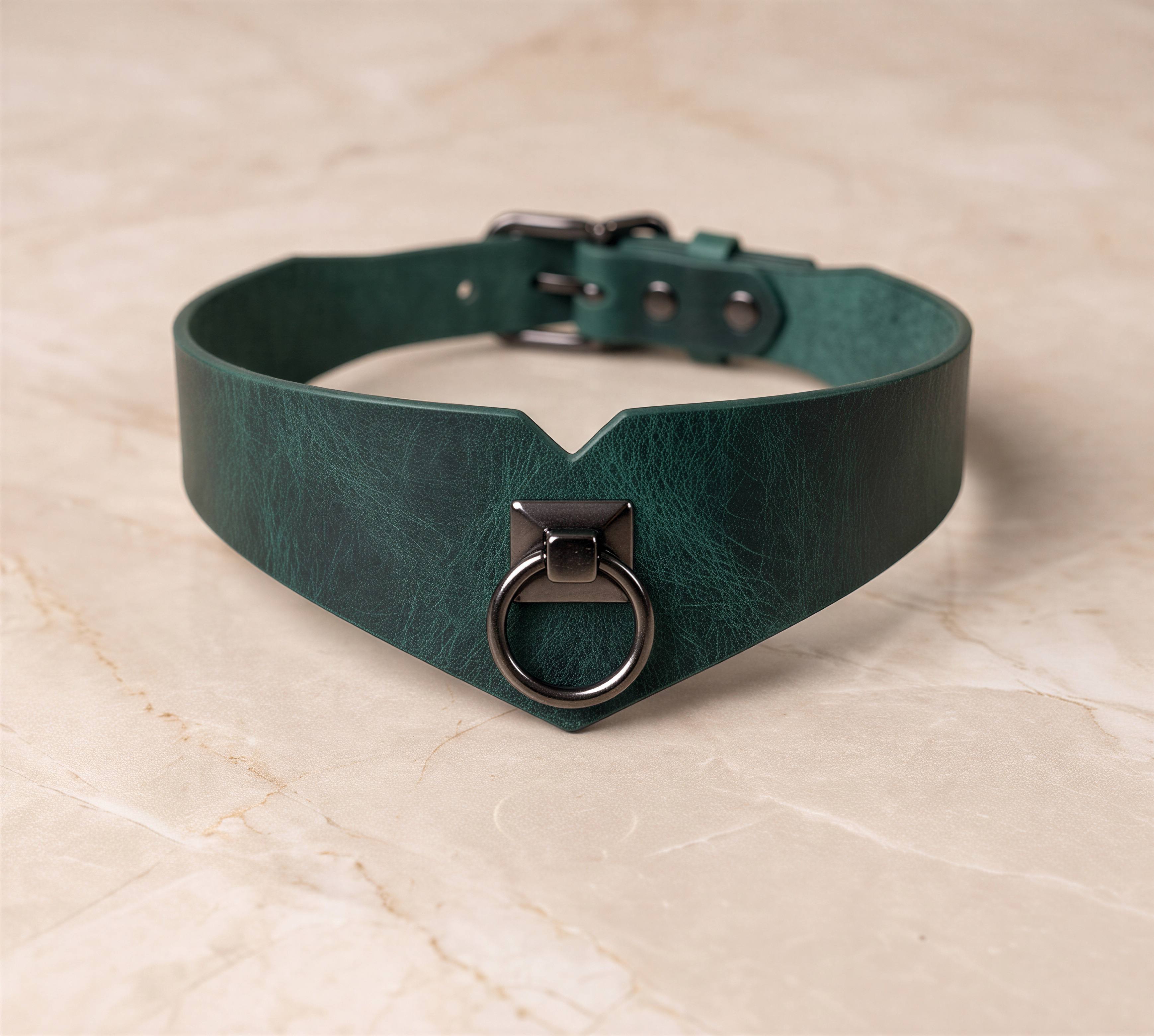 A dark green leather choker collar with a metal ring and buckle.