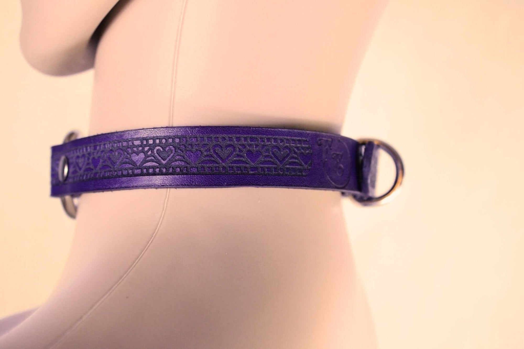 Elegant purple leather bondage collar with intricate design, perfect for discreet BDSM wear and submissive jewelry.