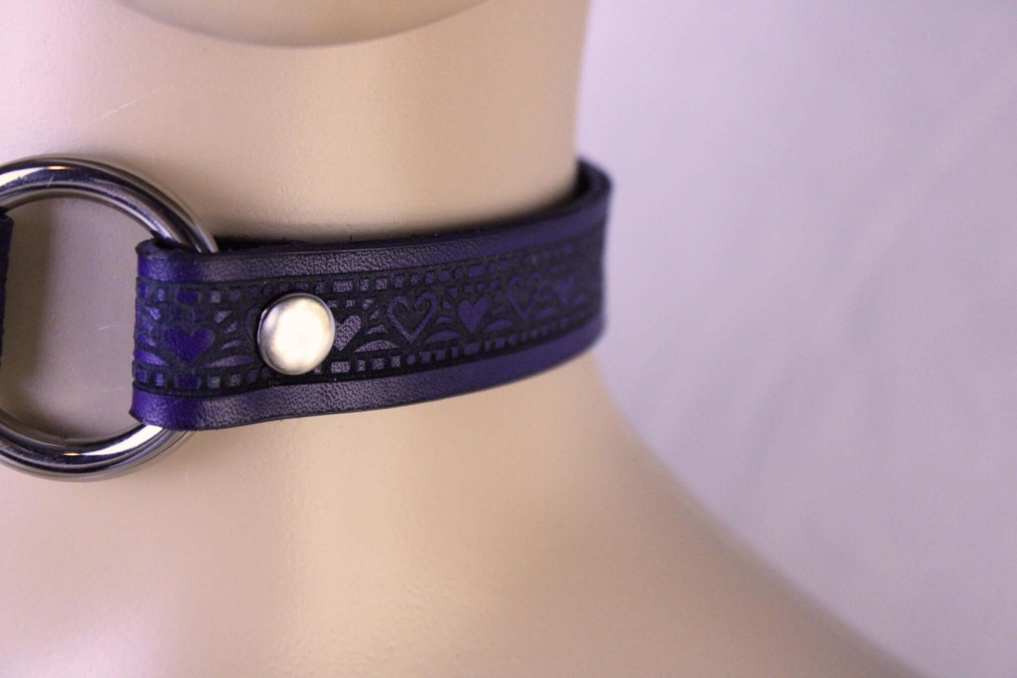 Elegant leather submissive collar with heart designs, perfect for discreet BDSM wear and everyday elegance.