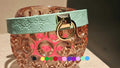 Elegant pastel leather collar with embossed floral design, featuring a gold ring, ideal for BDSM and sub gear.