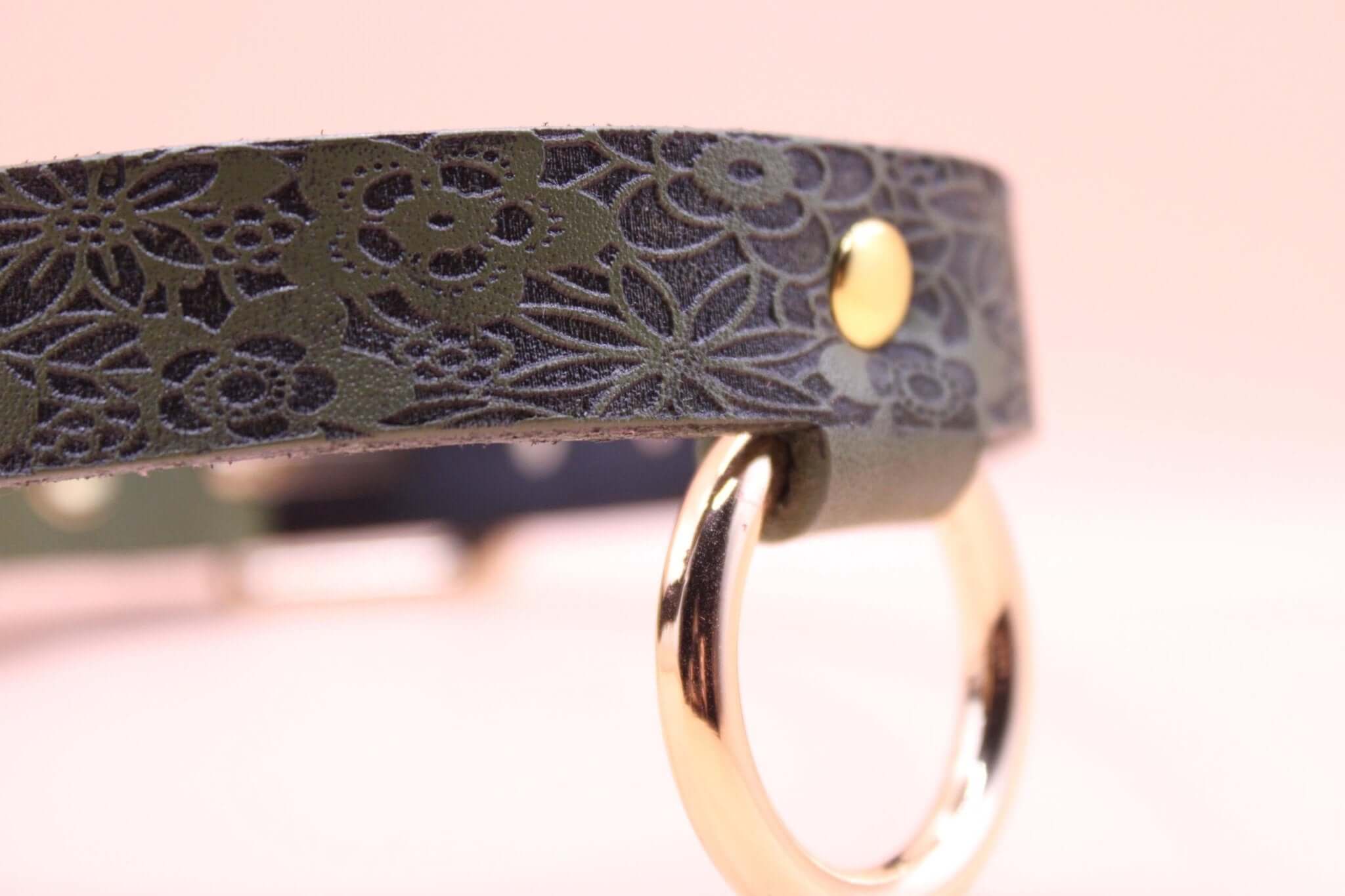 Elegant leather day collar with floral design and gold ring, perfect for discreet submissive jewelry and BDSM wear.