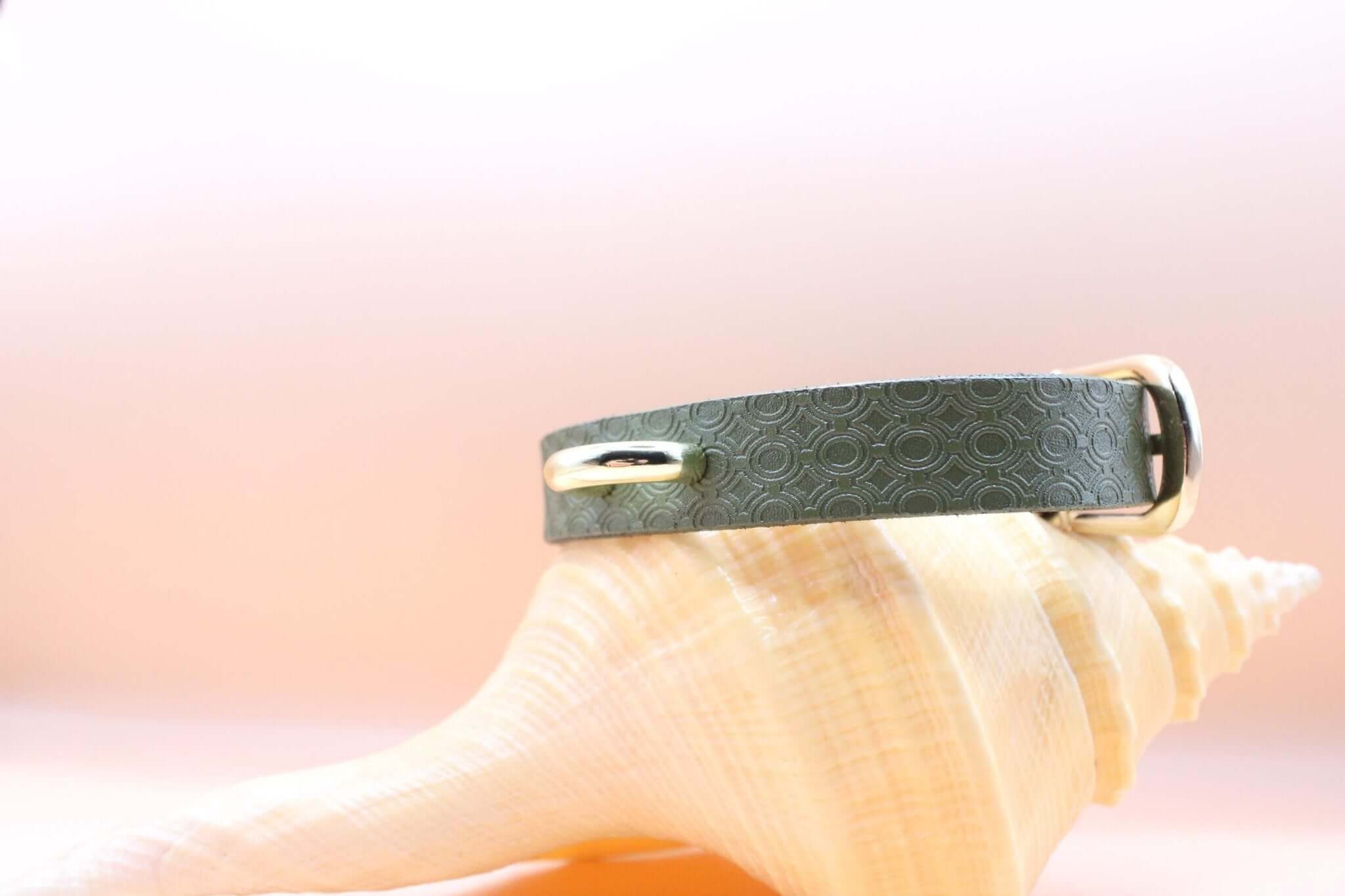 Elegant green leather day collar for BDSM, discreet submissive jewelry with stylish design and golden accents.