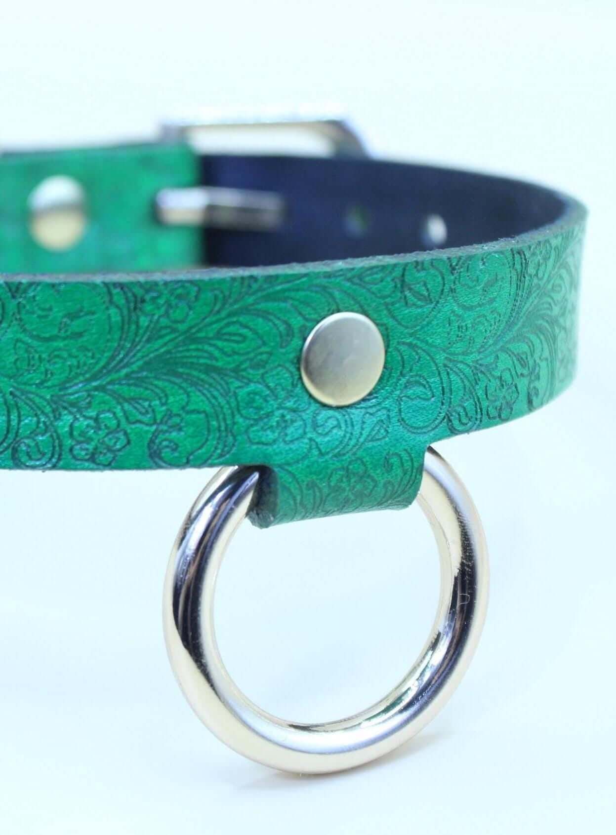 Emerald green submissive collar with floral design, perfect BDSM jewelry for discreet day wear and intimate moments.