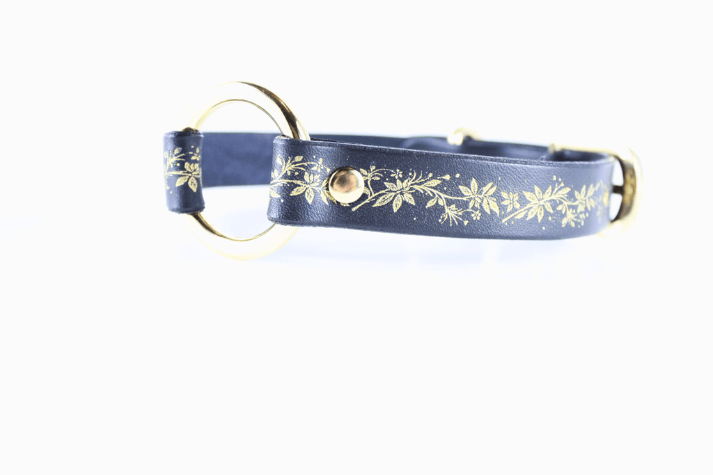 Black Leather Fetish Collar featuring a golden floral pattern and polished O-ring for bondage or fashion.