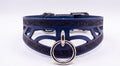 A blue leather choker necklace with a metal ring and a decorative pattern on the front.