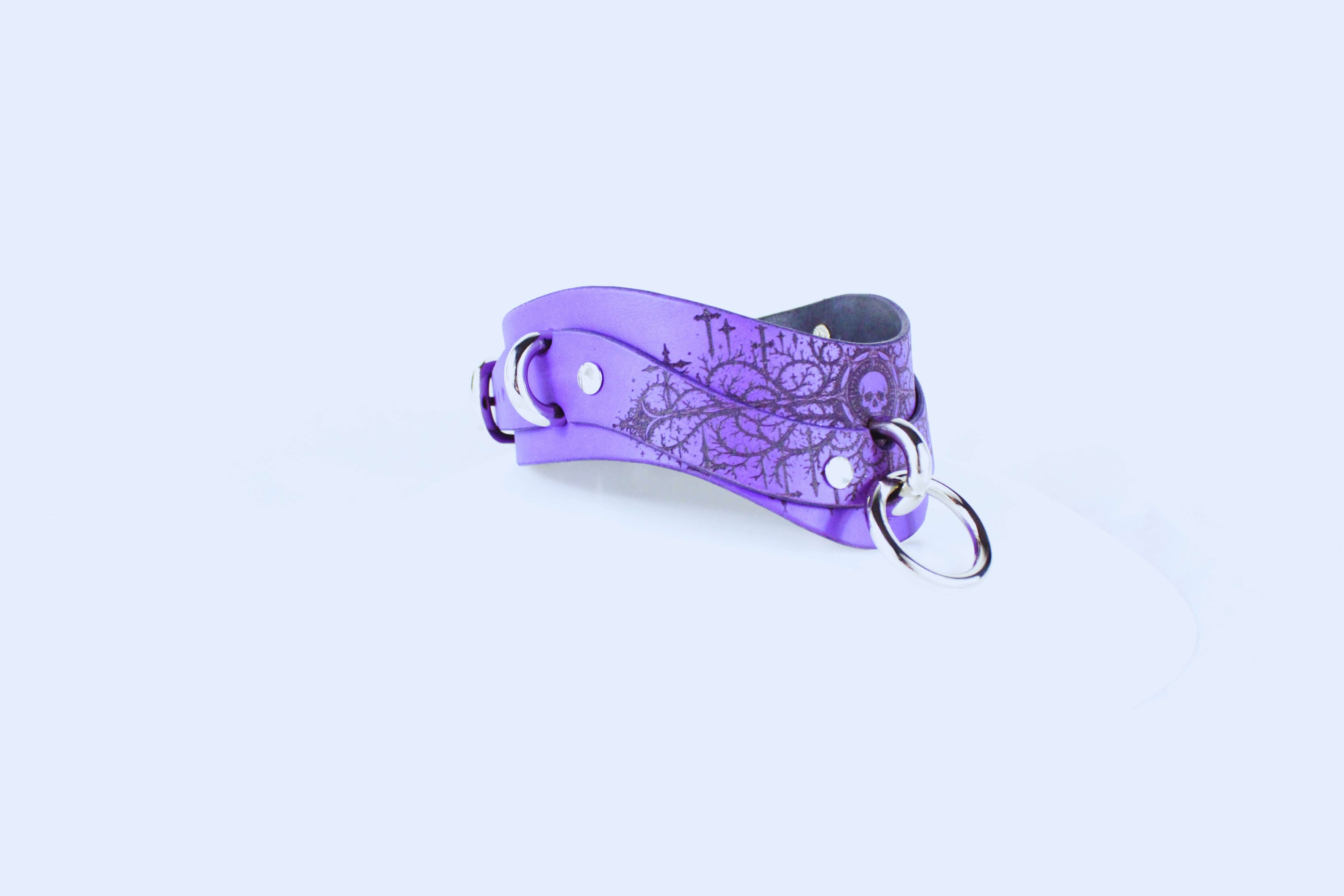 Gothic Skull BDSM Collar – purple leather choker with intricate gothic design and O-ring detail.