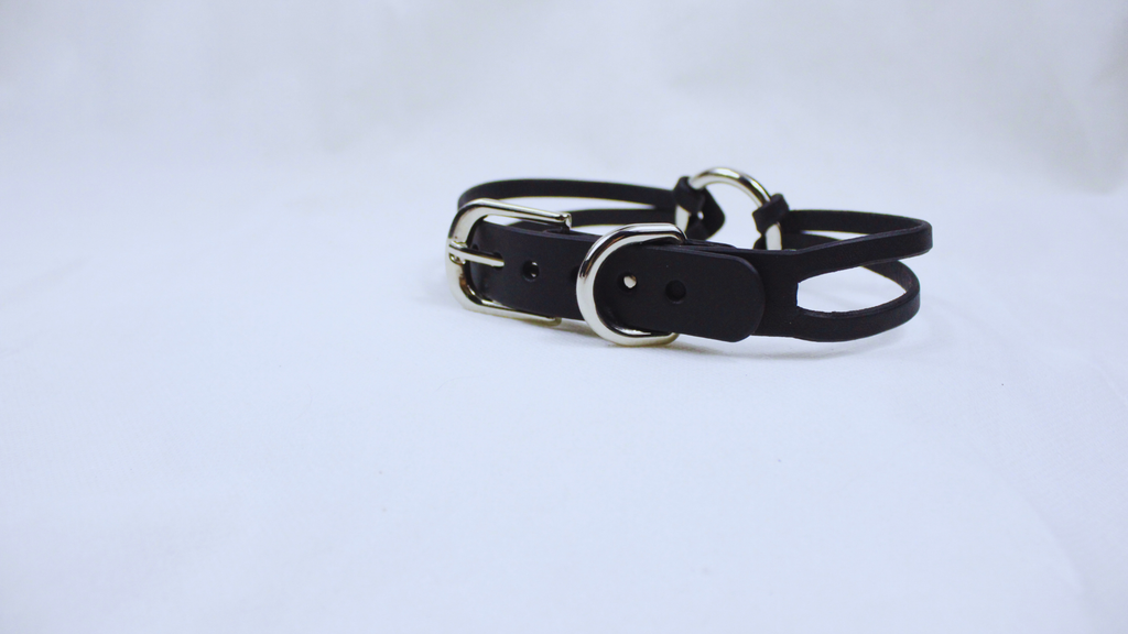 A black leather belt with a silver buckle is shown against a white background.