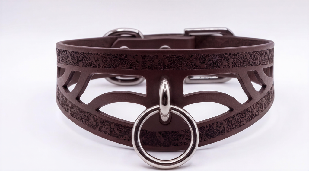 A brown leather choker collar with a metal ring and buckle.