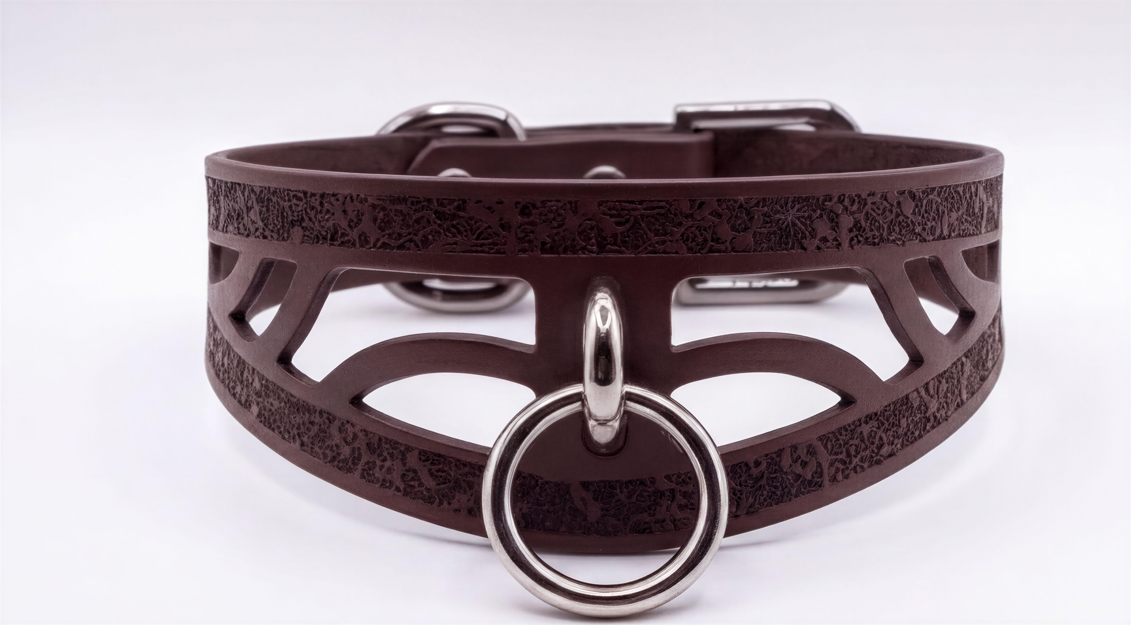 A brown leather choker collar with a metal ring and buckle.
