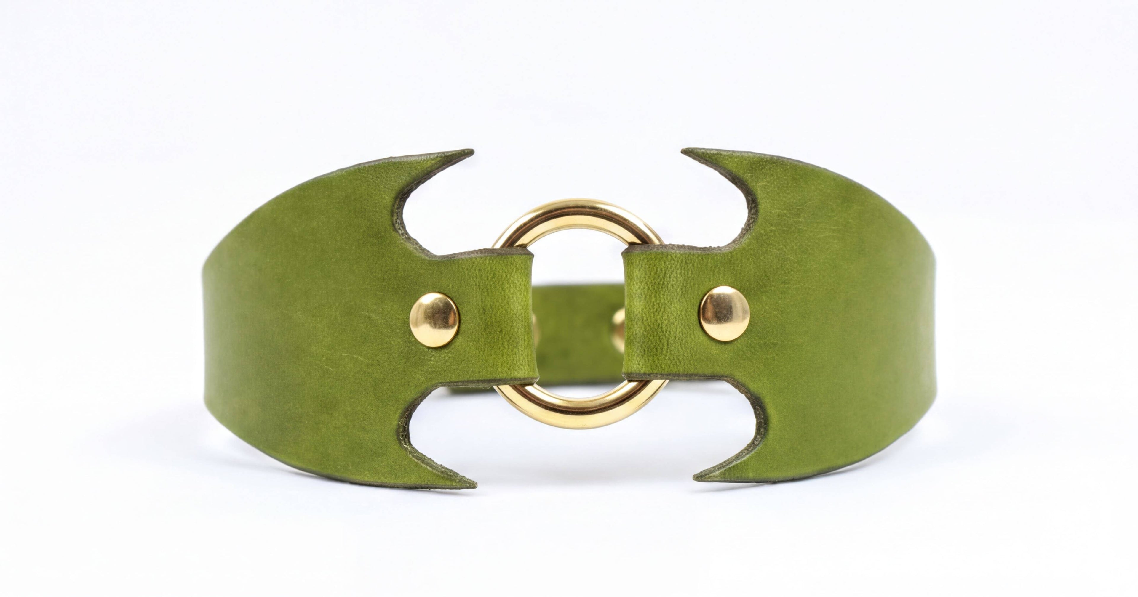 A green leather bracelet with a gold-colored metal clasp and two curved metal pieces.