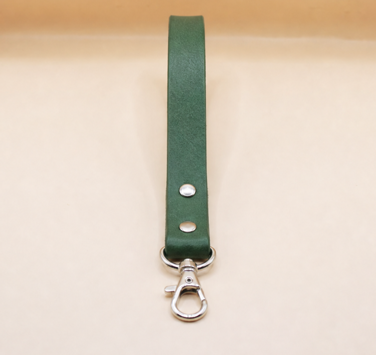 A green leather strap with a metal clasp and hook attached to it.