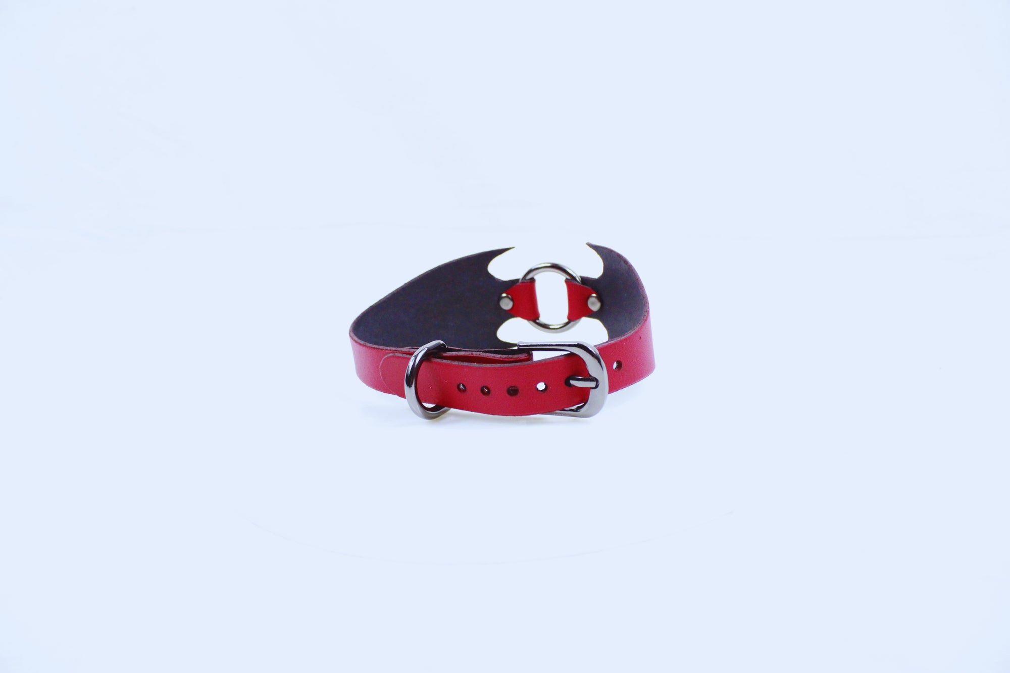 A red leather belt with a silver buckle is shown against a white background.